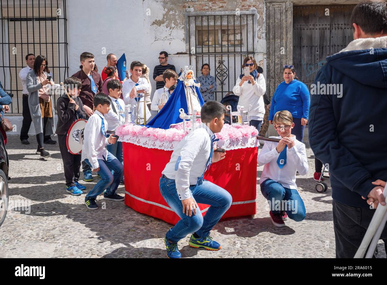 Kids with cloaks and hoods (Capirotes) at Holy Week Procession (Semana Santa) - Arcos de la Frontera, Cadiz, Spain Stock Photo