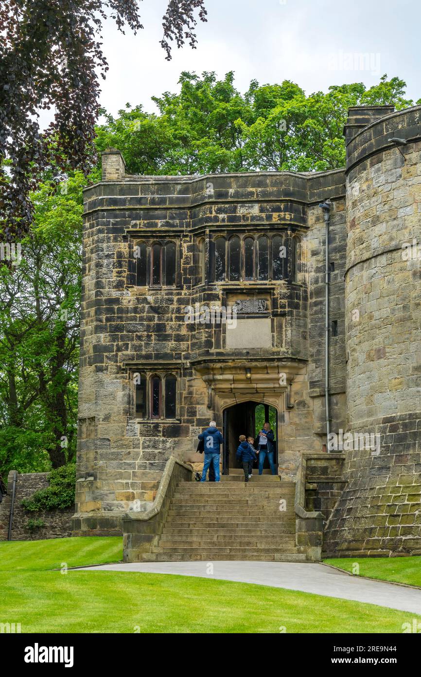 People entering doorway to castle interior, Skipton Castle, Skipton, North Yorkshire, England, UK Stock Photo