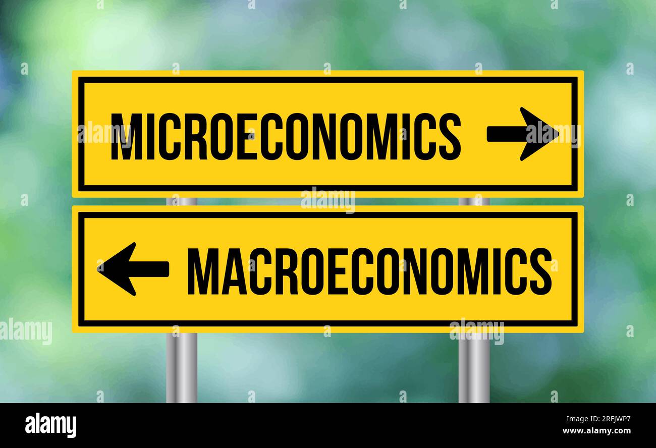 Microeconomics or macroeconomics road sign on blur background Stock Photo