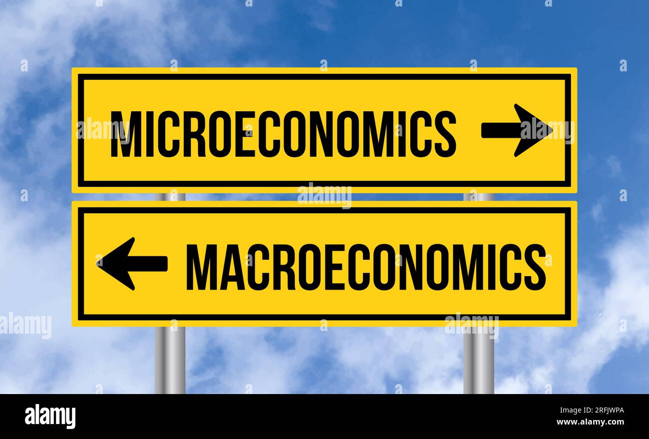 Microeconomics or macroeconomics road sign on cloudy sky background Stock Photo