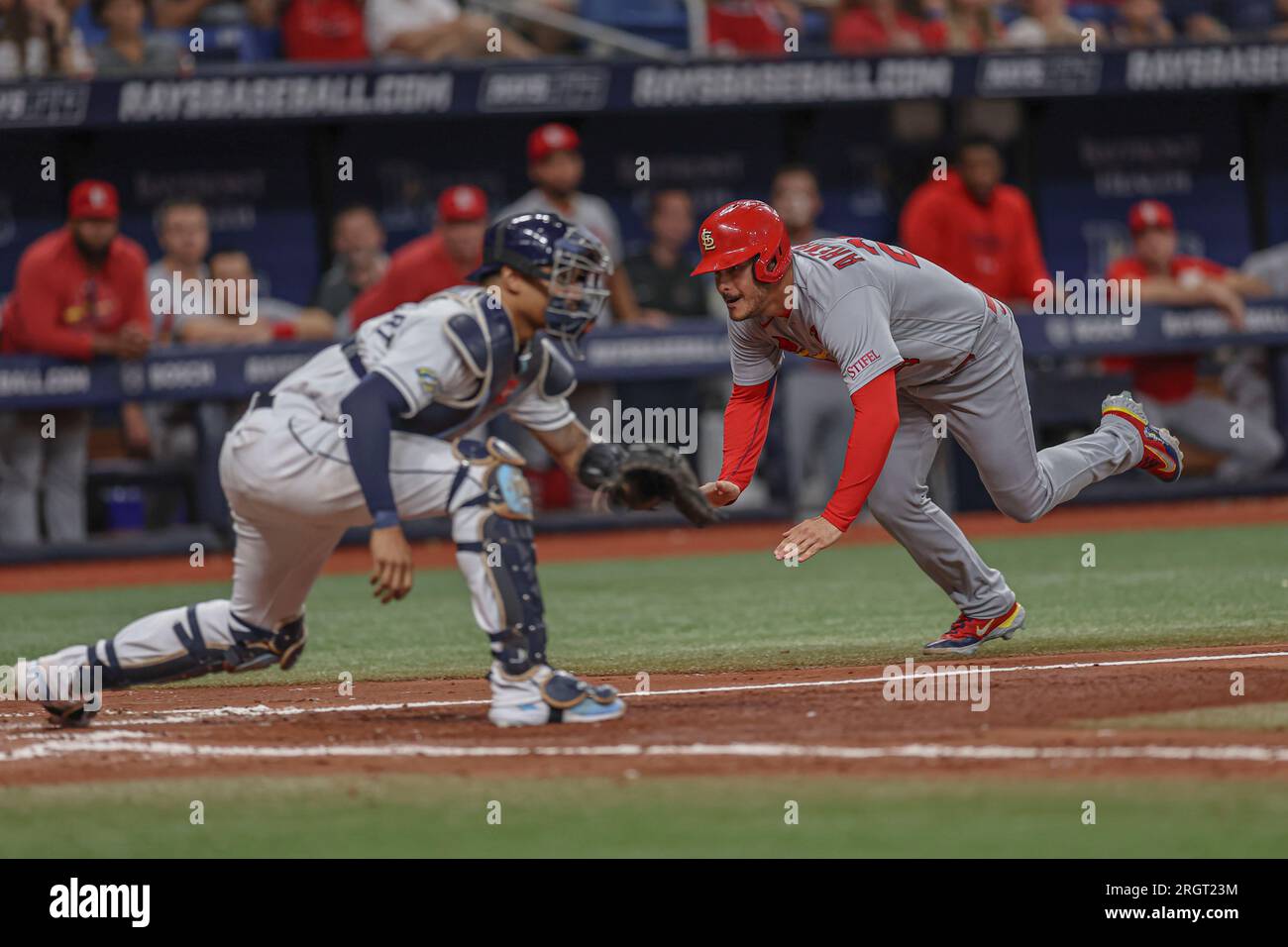 St. Petersburg, FL USA; St. Louis Cardinals third baseman Nolan Arenado (28) is safe at home sliding under the tag of Tampa Bay Rays catcher Christian Stock Photo