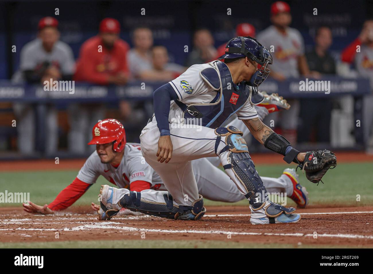 St. Petersburg, FL USA; St. Louis Cardinals third baseman Nolan Arenado (28) is safe at home sliding under the tag of Tampa Bay Rays catcher Christian Stock Photo