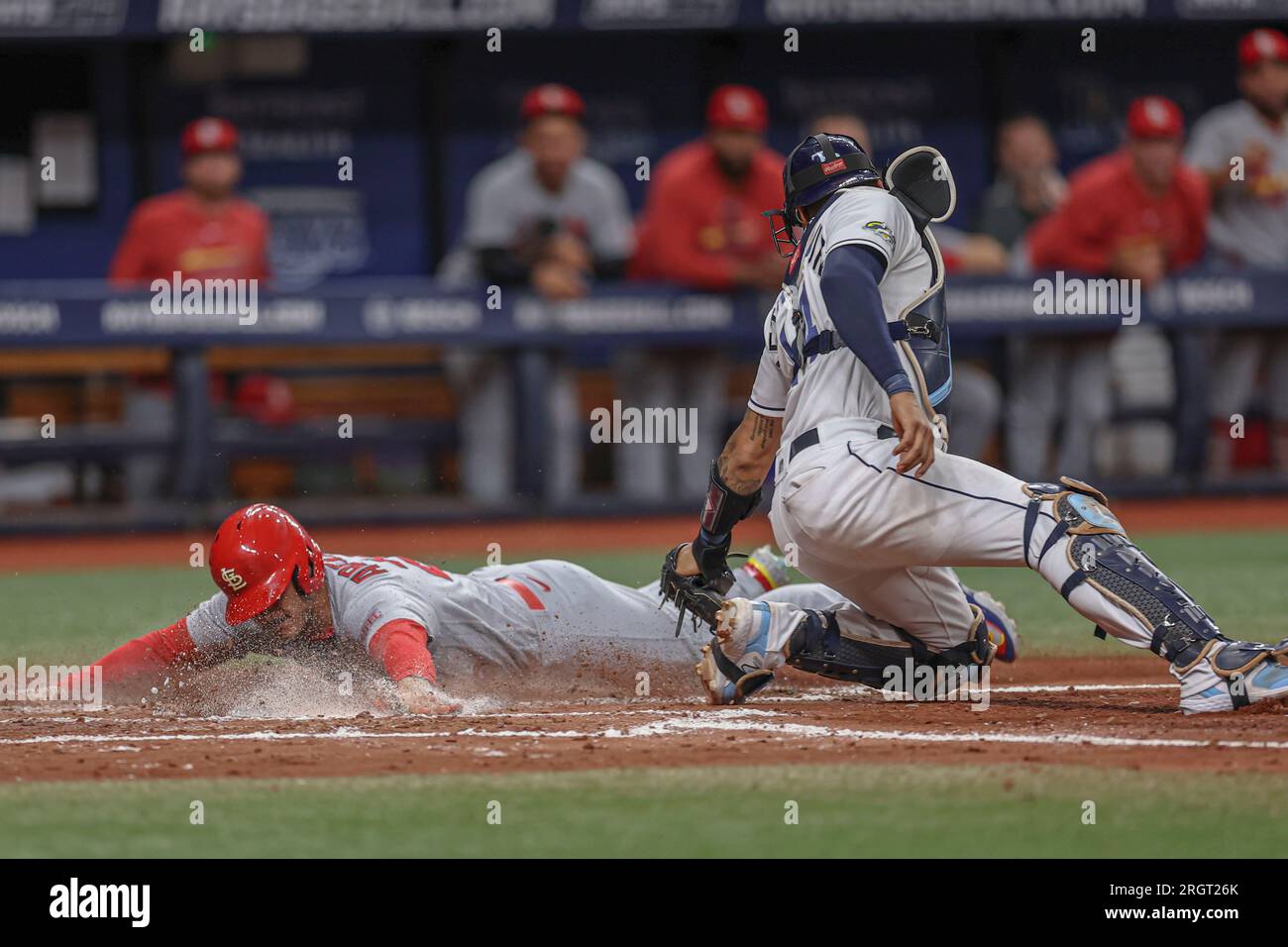 St. Petersburg, FL USA; St. Louis Cardinals third baseman Nolan Arenado (28) is safe at home sliding under the tag of Tampa Bay Rays catcher Christian Stock Photo