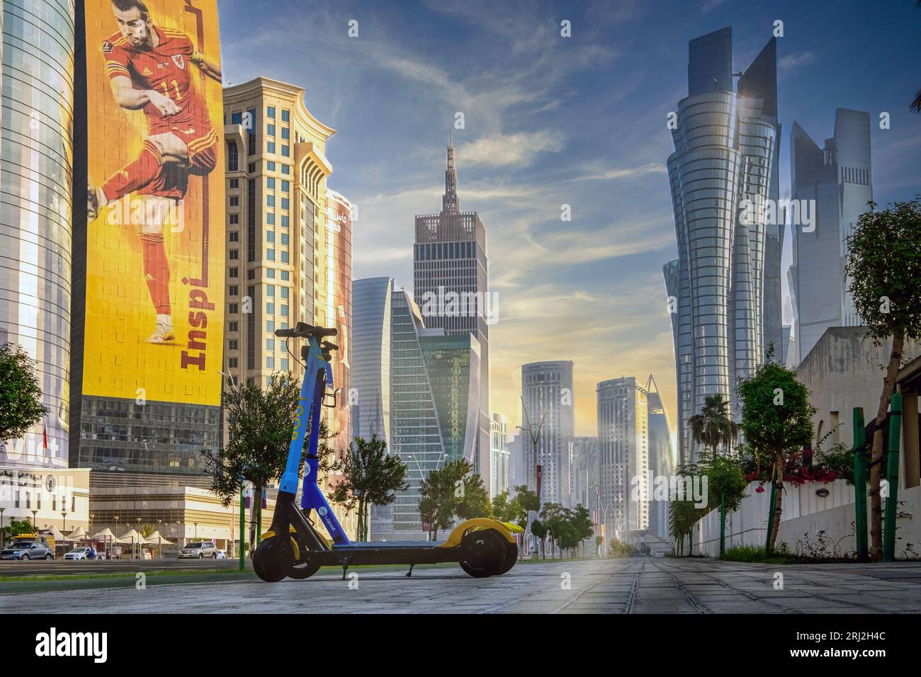 As the FIFA World Cup fervor grips Qatar, a stunning photo captures the exquisite Corniche road. Bathed in the warm hues of a descending sun, the road Stock Photo