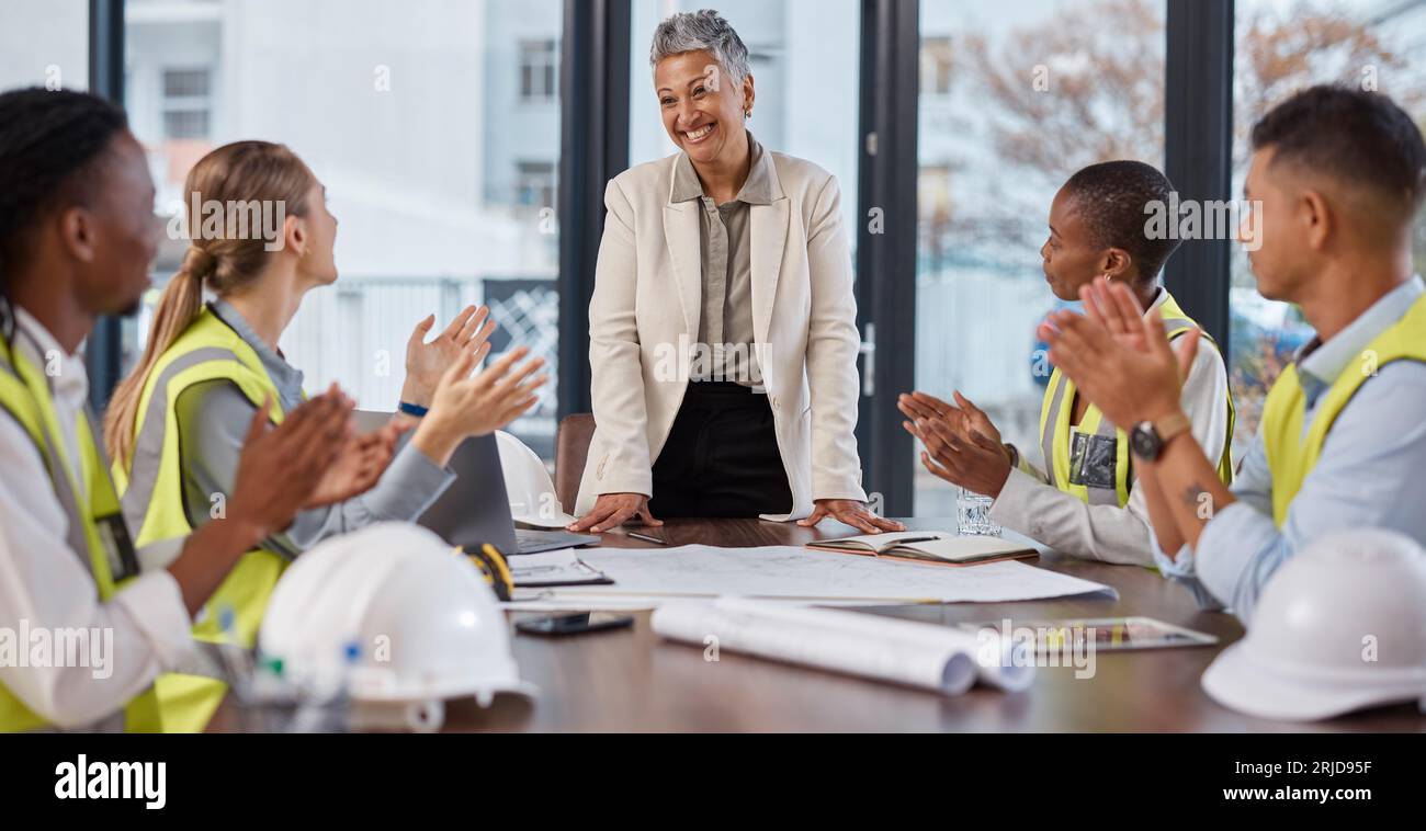 Applause, talking and construction workers in a meeting with a manager for architecture success. Happy, team and architects clapping for a Stock Photo