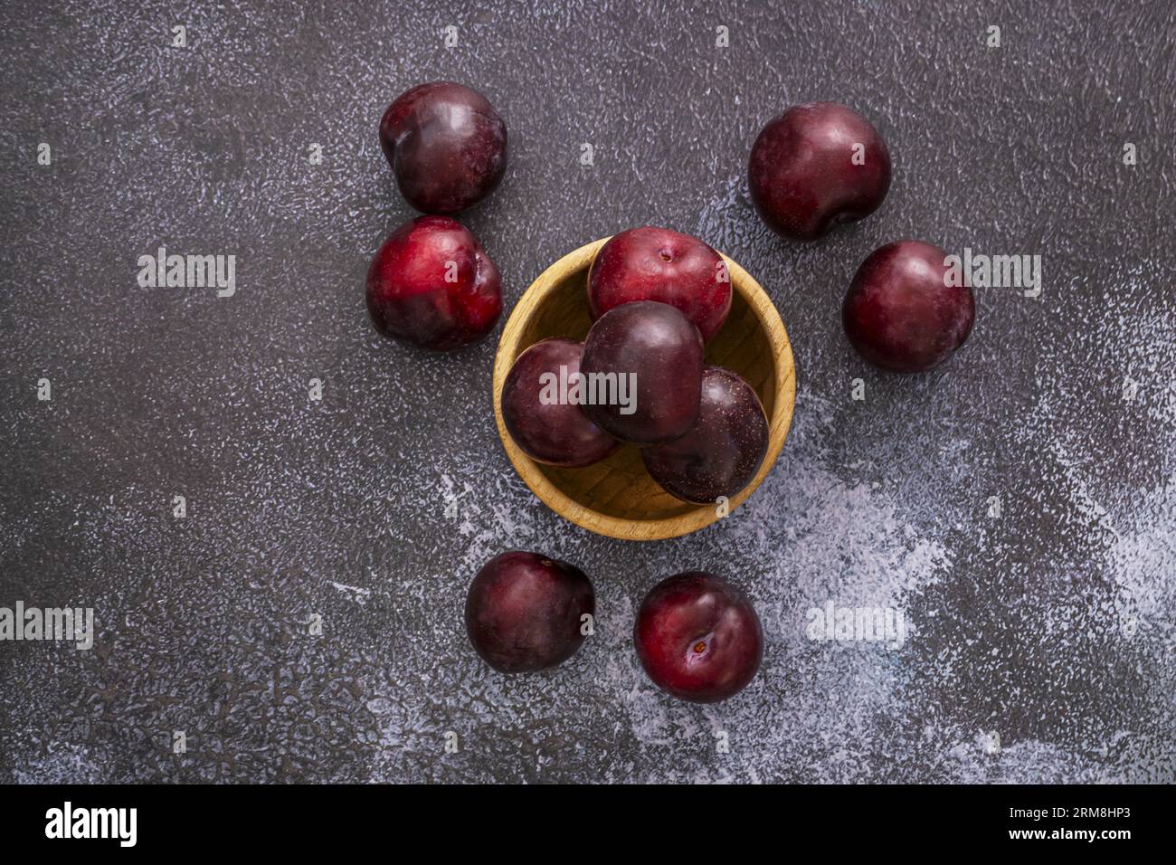 The black plum is one of the varieties of the Prunus species, native to Asia. It is a round drupe, with dark skin, between violet and black with bluis Stock Photo