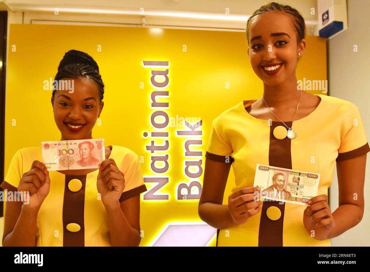 (150723)--NAIROBI, July 22, 2015 -- Two attendants display a Chinese currency note and a Kenyan Shilling note during the opening ceremony of a new branch of the National Bank of Kenya which will host a clearing house for Chinese renminbi (RMB) in Nairobi, Kenya, July 22, 2015. The National Bank of Kenya (NBK) has opened a new branch that will host a clearing house for Chinese renminbi (RMB) that would allow the settlement of trade deals to help boost economic growth. )(azp) KENYA-NAIROBI-ECONOMY-CHINESE CURRENCY-CLEARING SERVICE SunxRuibo PUBLICATIONxNOTxINxCHN   150723 Nairobi July 22 2015 Tw Stock Photo