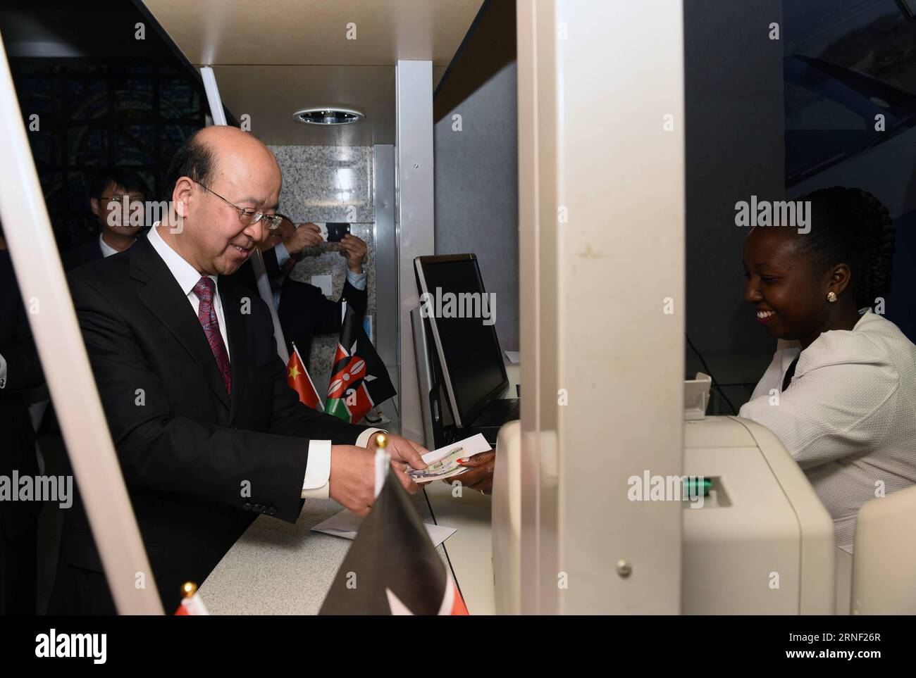 (160713) -- NAIROBI, July 13, 2016 -- Chinese Ambassador to Kenya Liu Xianfa (L) exchanges Chinese currency RMB into Kenyan Shilling at the headquarter of Kenya s CFC Stanbic Bank in Nairobi, capital of Kenya, July 13, 2016. Kenya s CFC Stanbic Bank on Wednesday became the first bank in the country to avail the Chinese currency, yuan, at its branches to facilitate trade between China and Kenya. ) KENYA-NAIROBI-CFC STANBIC BANK-CNY CURRENCY TRADING LixBaishun PUBLICATIONxNOTxINxCHN   160713 Nairobi July 13 2016 Chinese Ambassador to Kenya Liu Xianfa l Exchanges Chinese Currency RMB into Kenyan Stock Photo