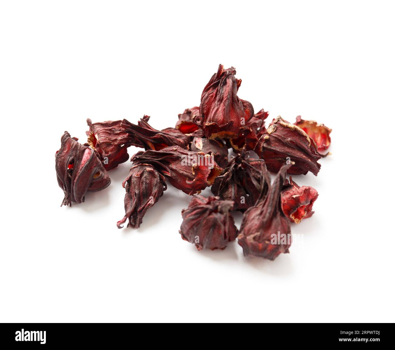 Hibiscus tea on a white background close-up. Dry flowers of red hibiscus on isolation. A handful of hibiscus for making tea. Stock Photo