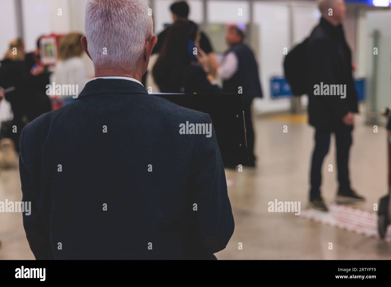 Meeting at the airport, person holding a placard card sign with welcome title text, greeting passenger on arrival, holding a name plate to greet trave Stock Photo