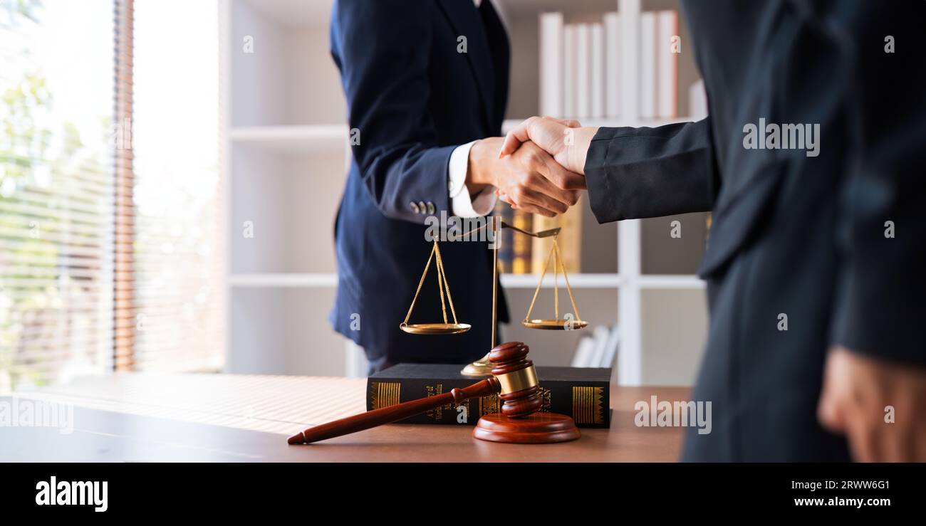 Businessman shaking hands to seal a deal with his partner deal lawyer or attorney discussing a contract agreement. legal, lawyer, real estate, justice Stock Photo