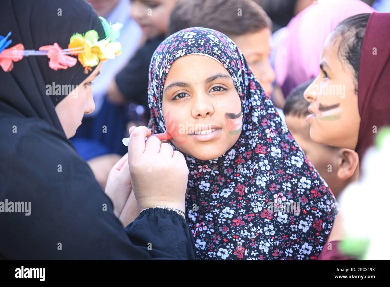 A Palestinian kid seen being face painted during the gather to commemorate the birth of the Prophet Muhammad, known in Arabic as “Mawlid al-Nabawi,” outside the Dome of the Rock in the Al-Aqsa Mosque complex, Islam’s third holiest site, in the Old City of Jerusalem. Stock Photo