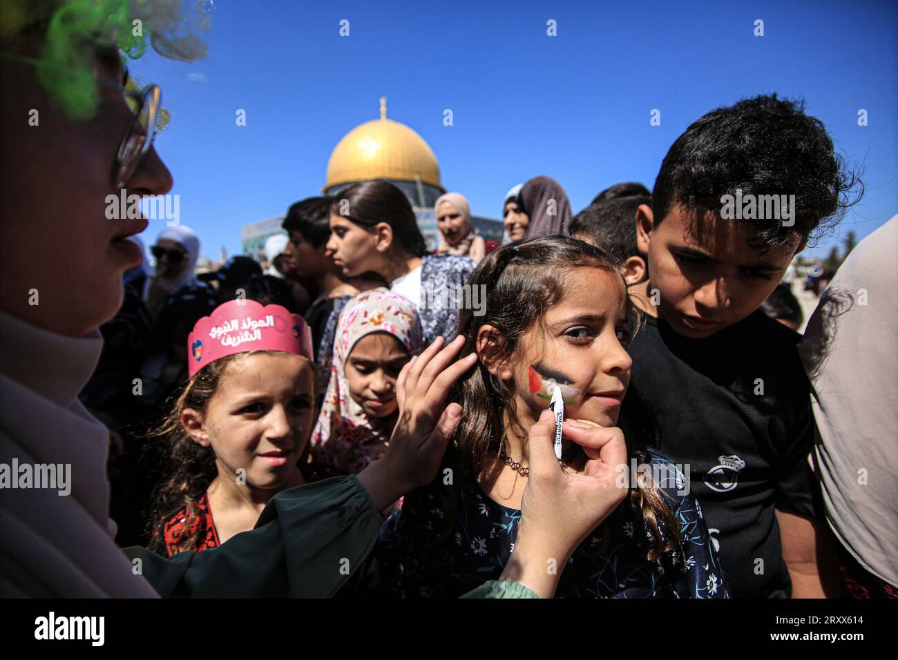 A Palestinian kid seen being face painted during the gather to commemorate the birth of the Prophet Muhammad, known in Arabic as “Mawlid al-Nabawi,” outside the Dome of the Rock in the Al-Aqsa Mosque complex, Islam’s third holiest site, in the Old City of Jerusalem. (Photo by Saeed Qaq / SOPA Images/Sipa USA) Stock Photo