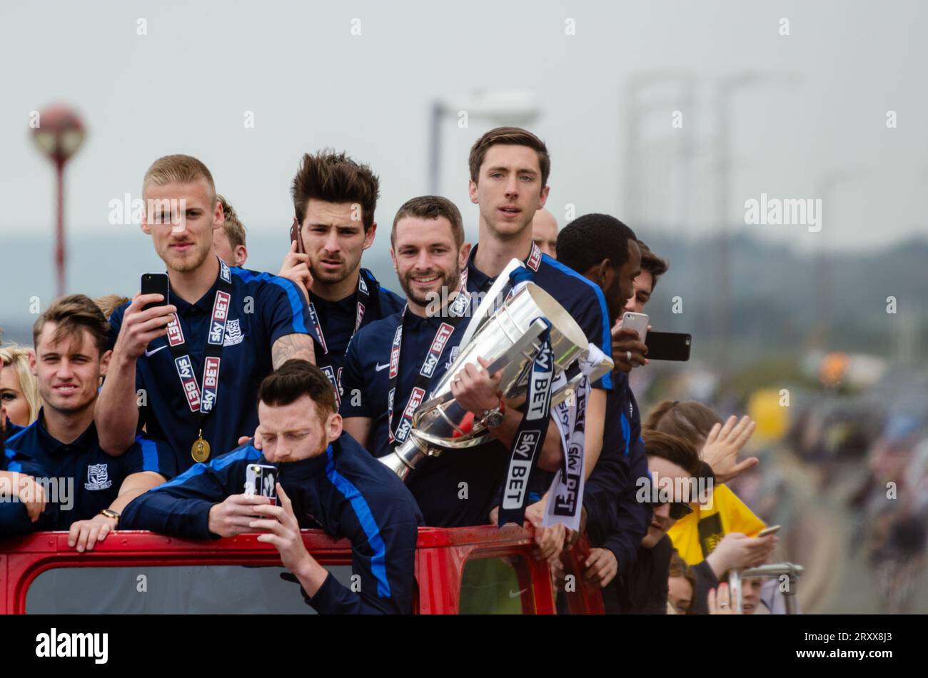 Southend United celebrated promotion to League One with an open top bus parade through the town and along the seafront. Players with winners trophy Stock Photo