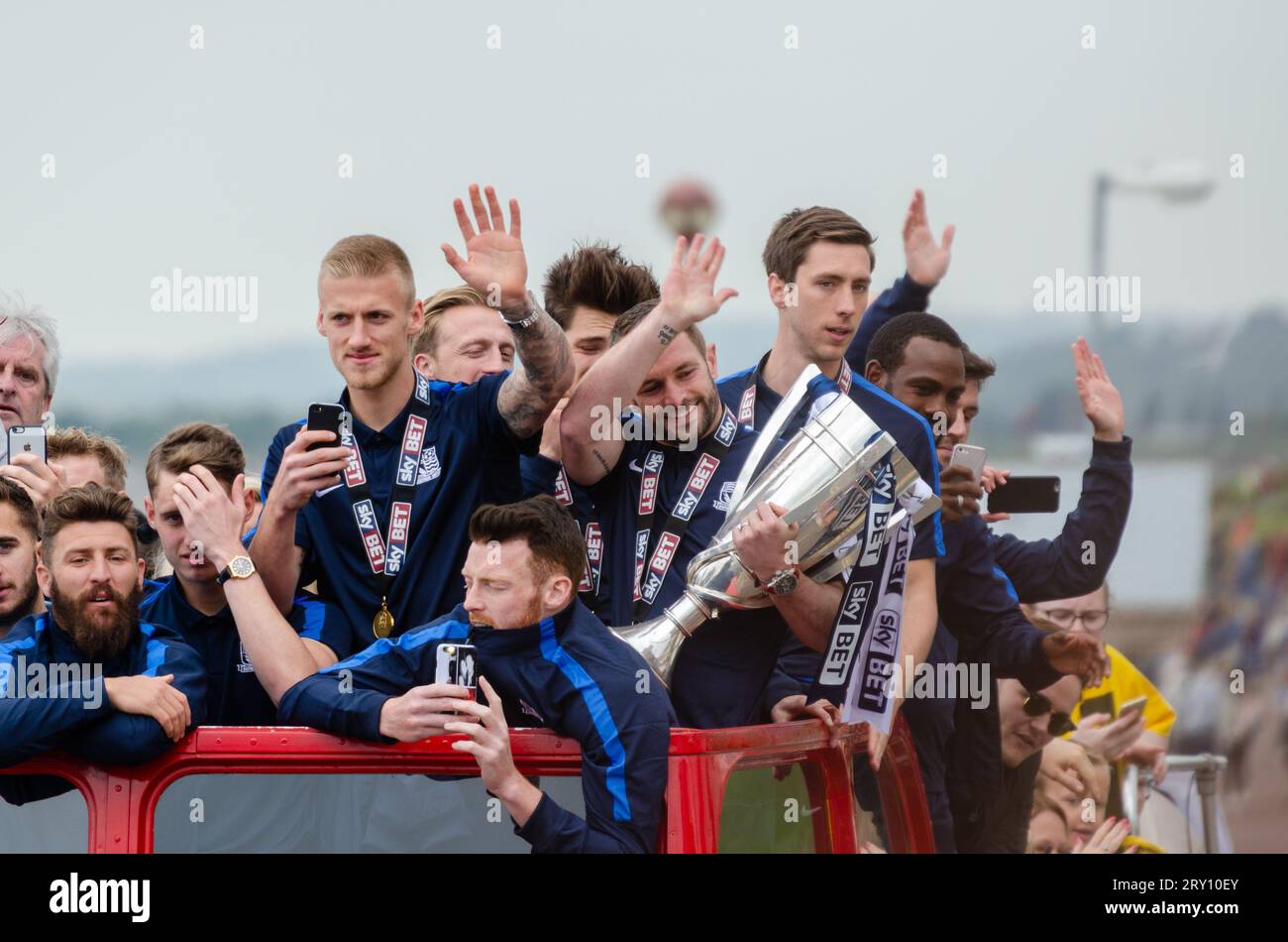 Southend United celebrated promotion to League One with an open top bus parade through the town and along the seafront. Players with winners trophy Stock Photo