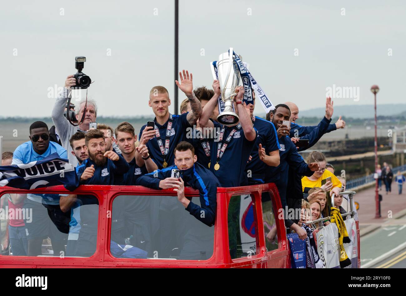 Southend United celebrated promotion to League One with an open top bus parade through the town and along the seafront. Players with winners trophy Stock Photo