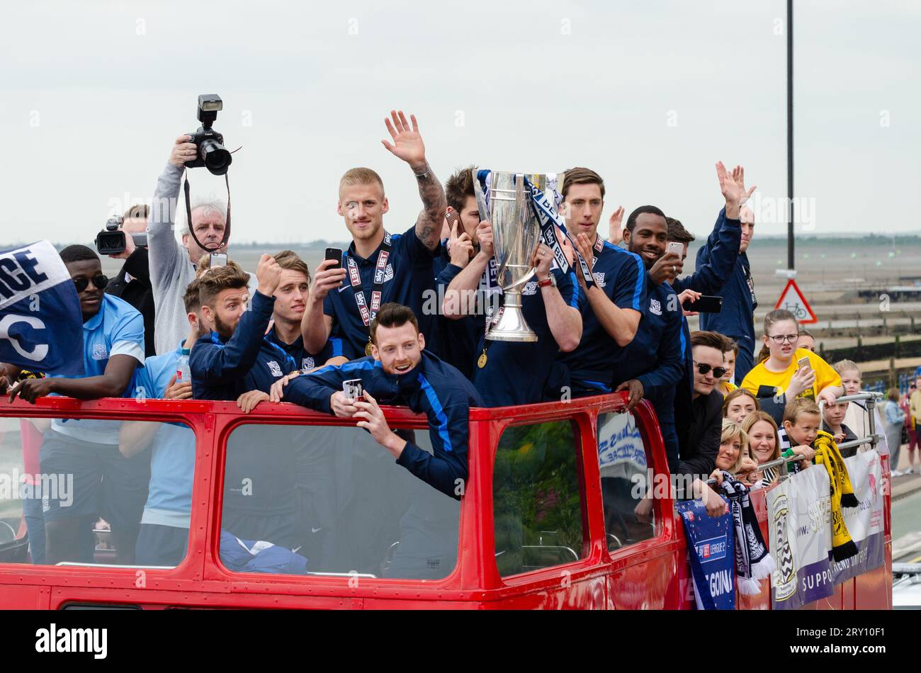 Southend United celebrated promotion to League One with an open top bus parade through the town and along the seafront. Players with winners trophy Stock Photo