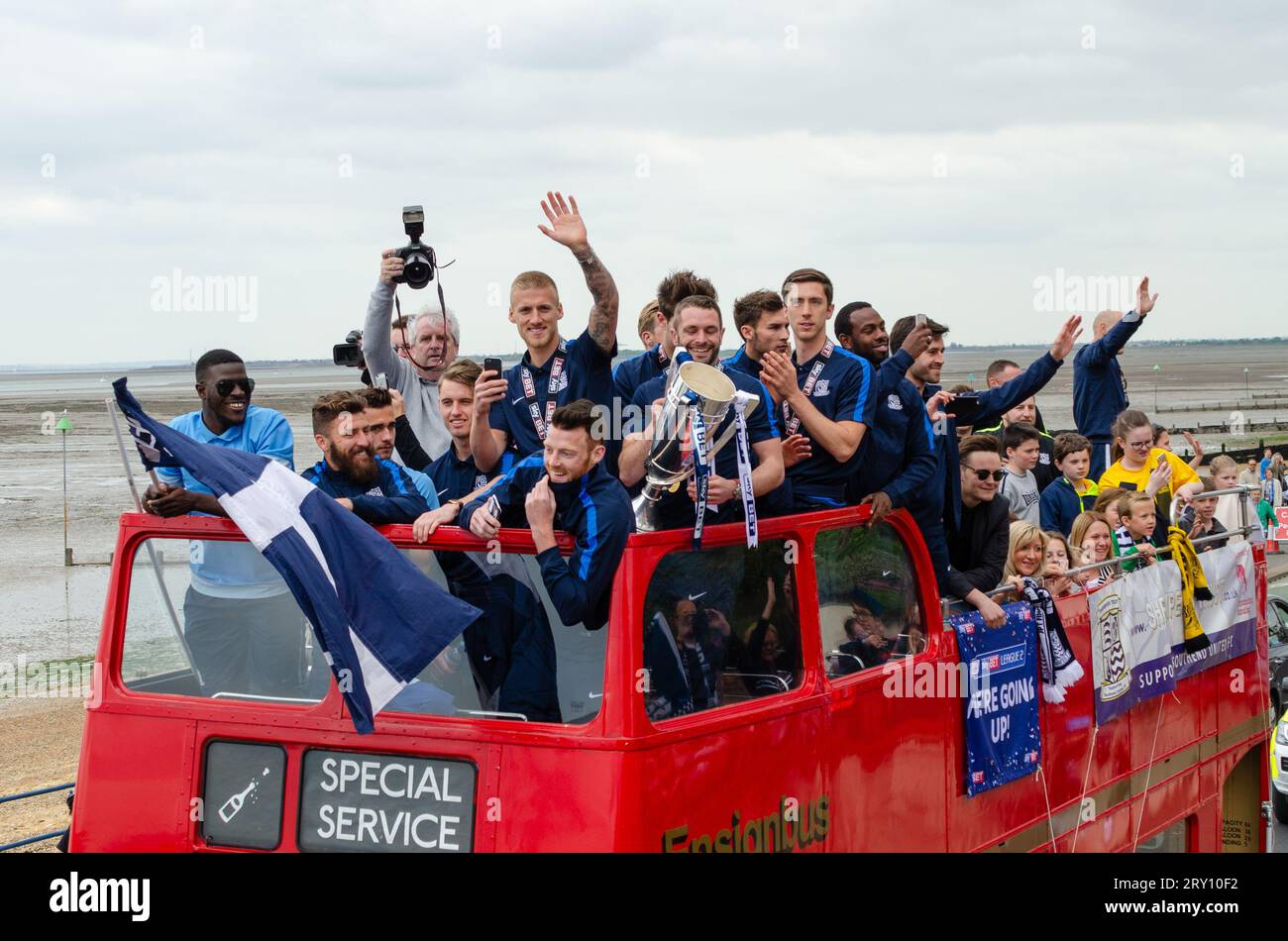 Southend United celebrated promotion to League One with an open top bus parade through the town and along the seafront. Players with winners trophy Stock Photo