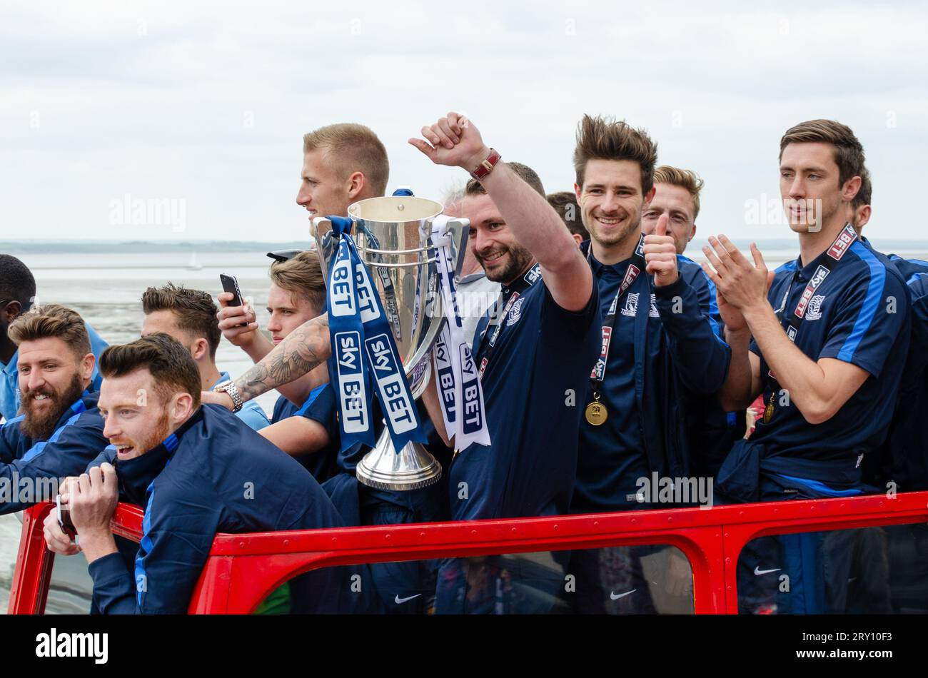 Southend United celebrated promotion to League One with an open top bus parade through the town and along the seafront. Players with winners trophy Stock Photo