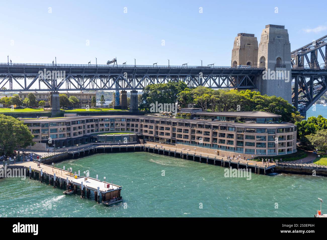 Park Hyatt hotel at Campbells Cove in Circular Quay beneath the Sydney Harbour bridge on the waterfront,Sydney The Rocks,NSW,Australia Stock Photo