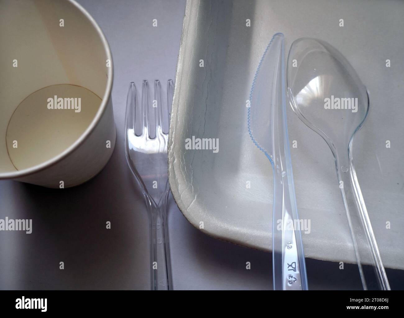 Single-use plastic cutlery. Plastic containers and trays used in takeaways. Stock Photo