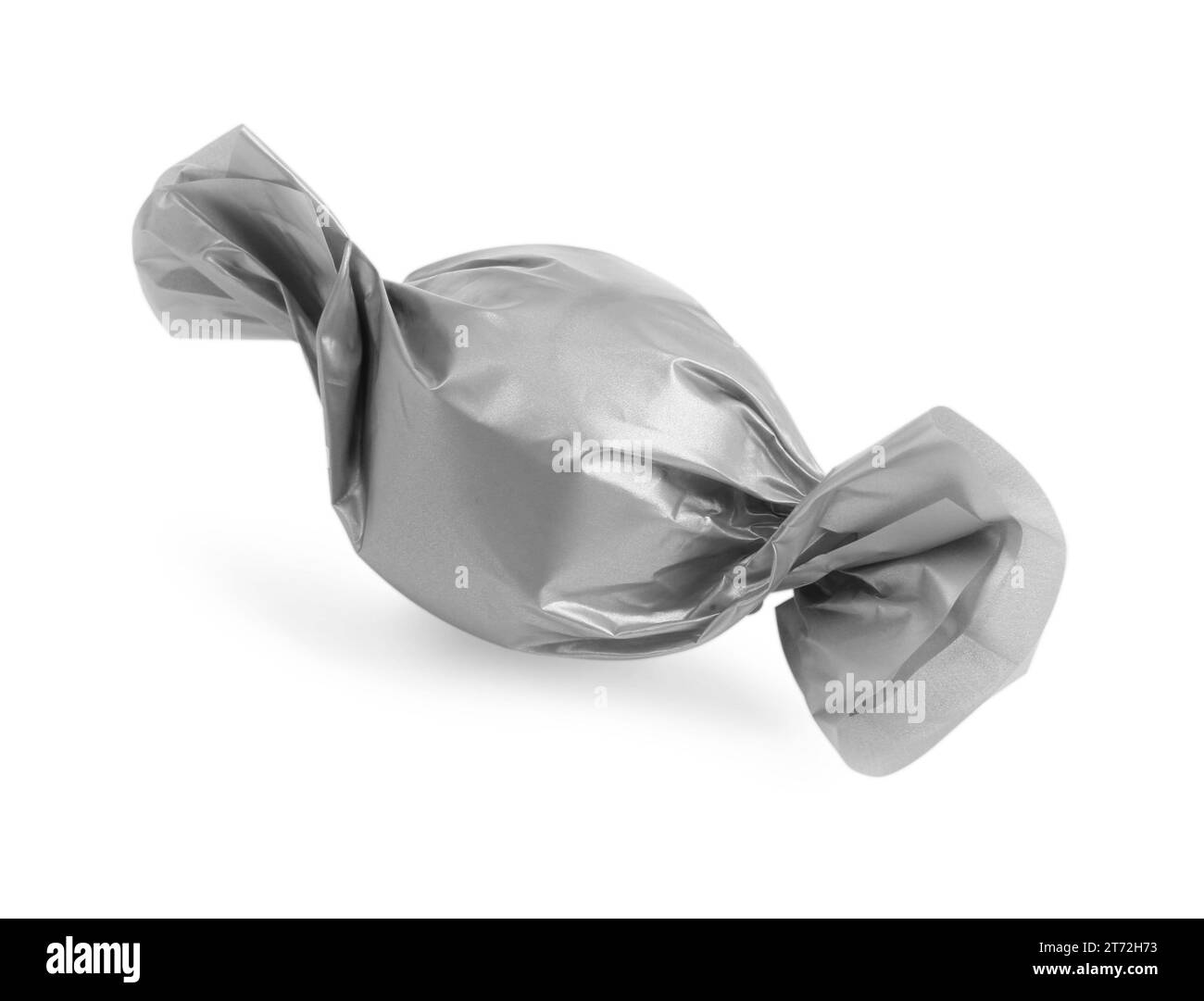 Tasty candy in silver wrapper isolated on white Stock Photo