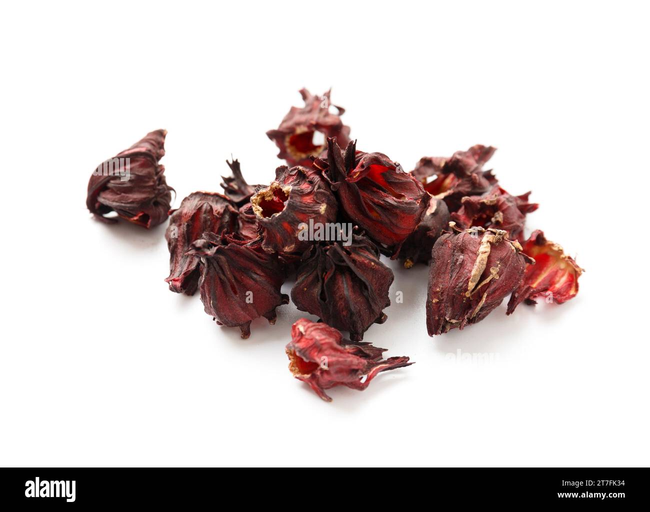 Hibiscus tea on a white background close-up. Dry flowers of red hibiscus on isolation. A handful of hibiscus for making tea. Stock Photo