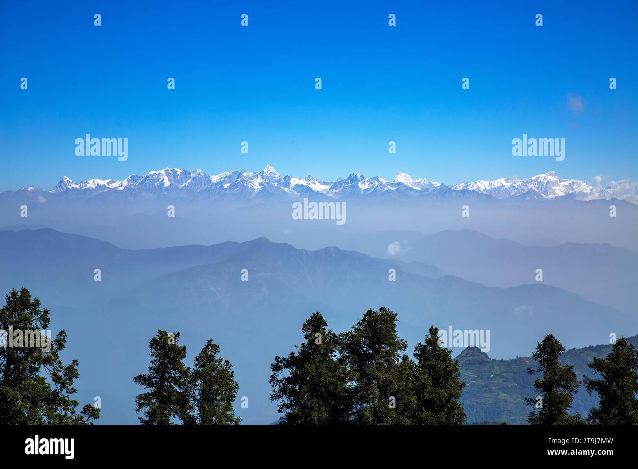 snow capped Himalayas from Tehri range in Dhanaulti tehsil of Tehri Garhwal district in Uttarakhand, India. Stock Photo