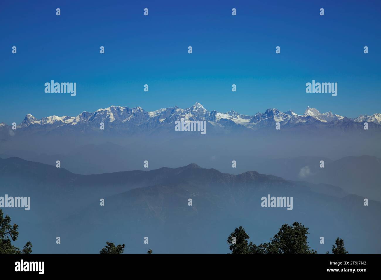 snow capped Himalayas from Tehri range in Dhanaulti tehsil of Tehri Garhwal district in Uttarakhand, India. Stock Photo