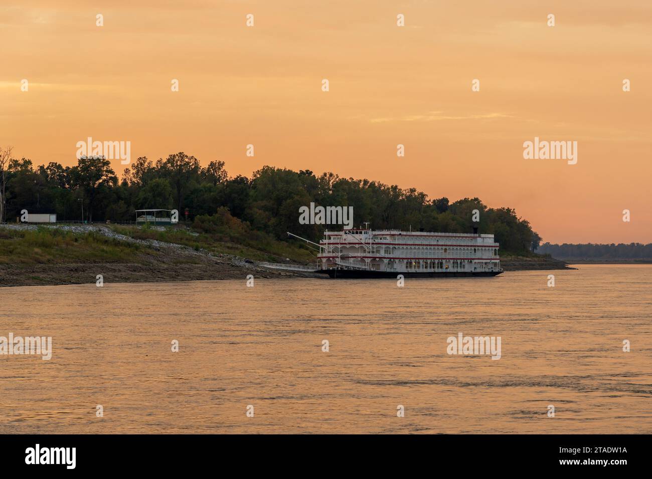 Old fashioned paddle steamer cruise boat docked by slipway in low water conditions on Mississippi river in Tennessee Stock Photo