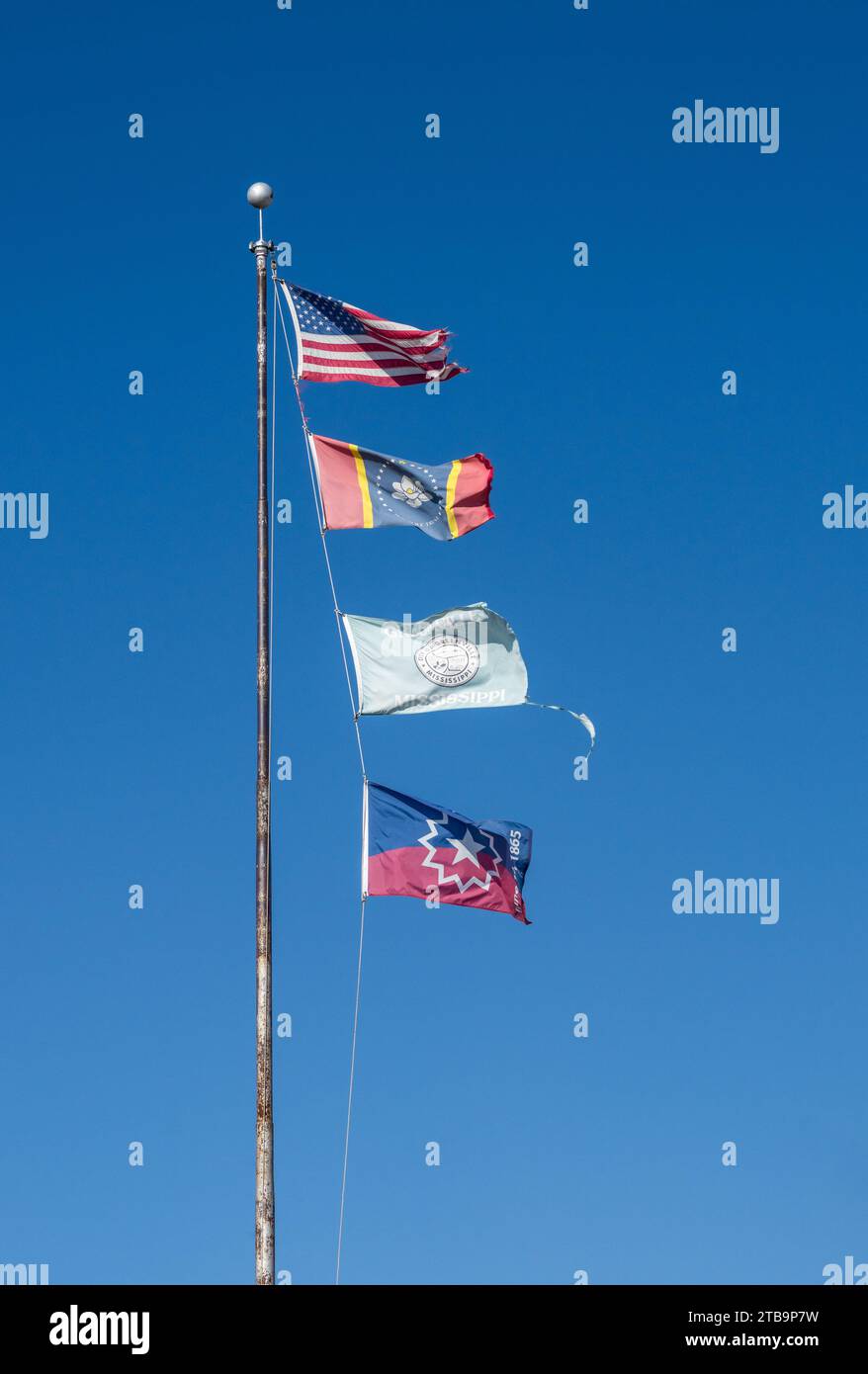 Flagpole with USA and Mississippi state flags, Greenville City flag and Juneteenth Flag in the town in Mississippi Stock Photo