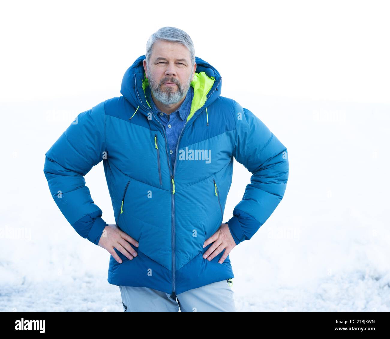 Man, 56 years, grey hair and beard, standing outside in winter with ...