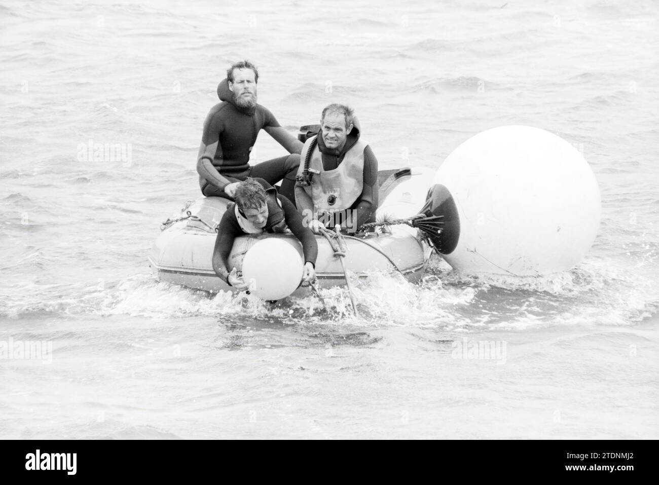 Crew of the RP 20 of the state police in the water at a buoy, Whizgle News from the Past, Tailored for the Future. Explore historical narratives, Dutch The Netherlands agency image with a modern perspective, bridging the gap between yesterday's events and tomorrow's insights. A timeless journey shaping the stories that shape our future Stock Photo