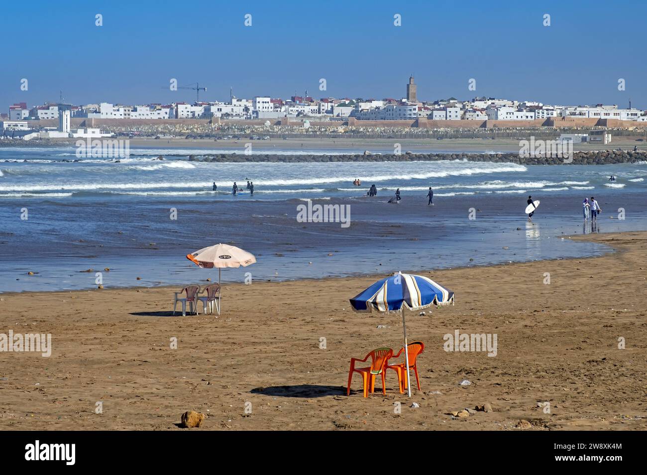 Surfing in the estuary of the river Bou Regreg and view over the commuter town Salé opposite the capital city Rabat, Rabat-Salé-Kénitra, Morocco Stock Photo