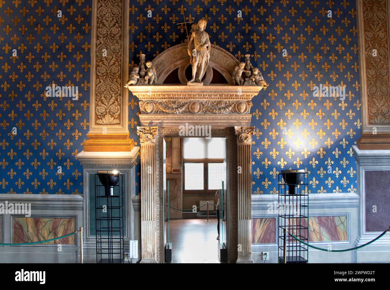 A Doorway in The Sala dei Gigli, Hall of the Lilies with a wall fresco of Fluer- de- lys inside The Palazzo Vecchio in Florence, Italy Stock Photo