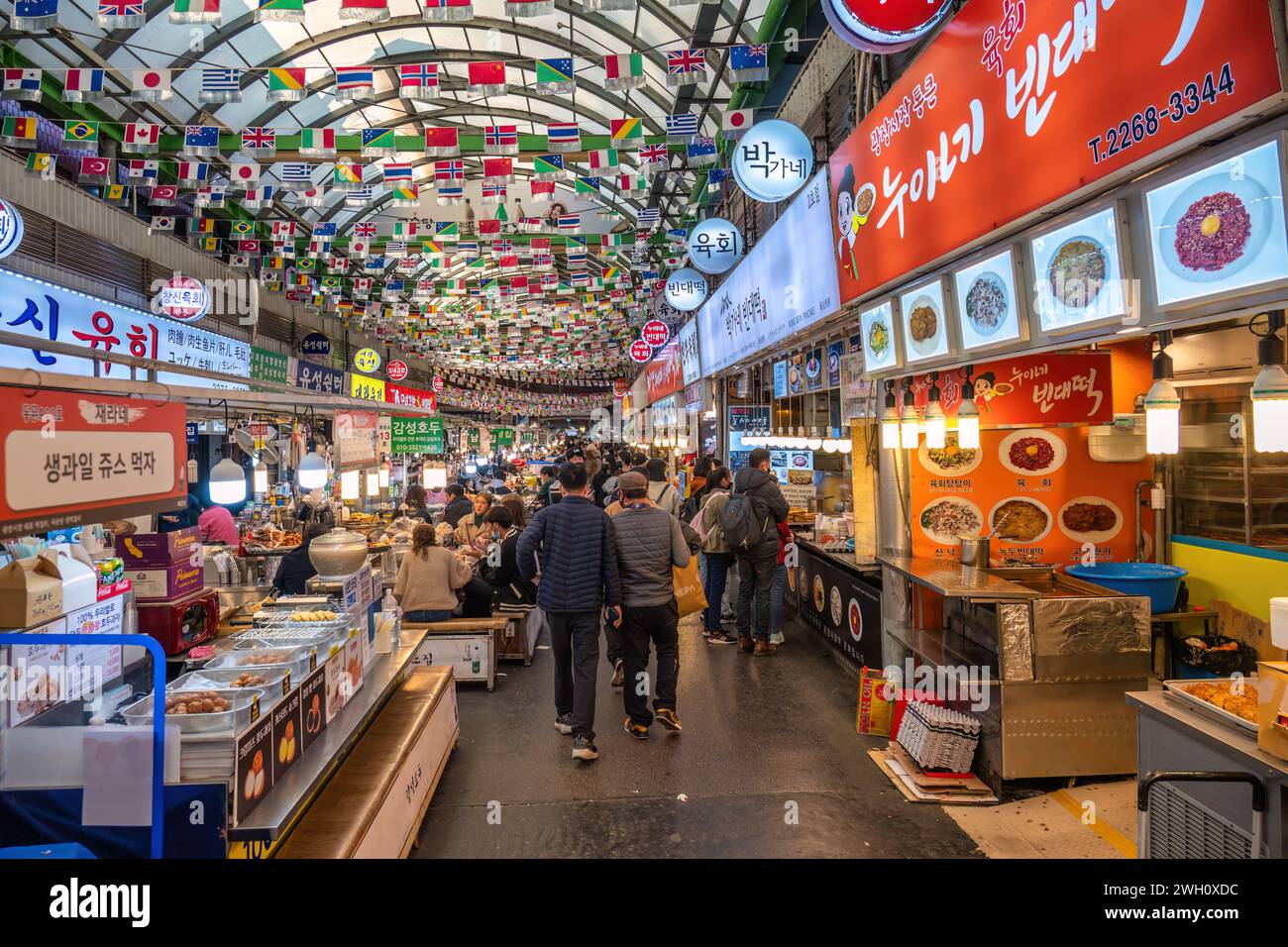 Seoul, South Korea - November 11, 2022 : shop and street food stall with many tourist at Gwangjang Market Stock Photo