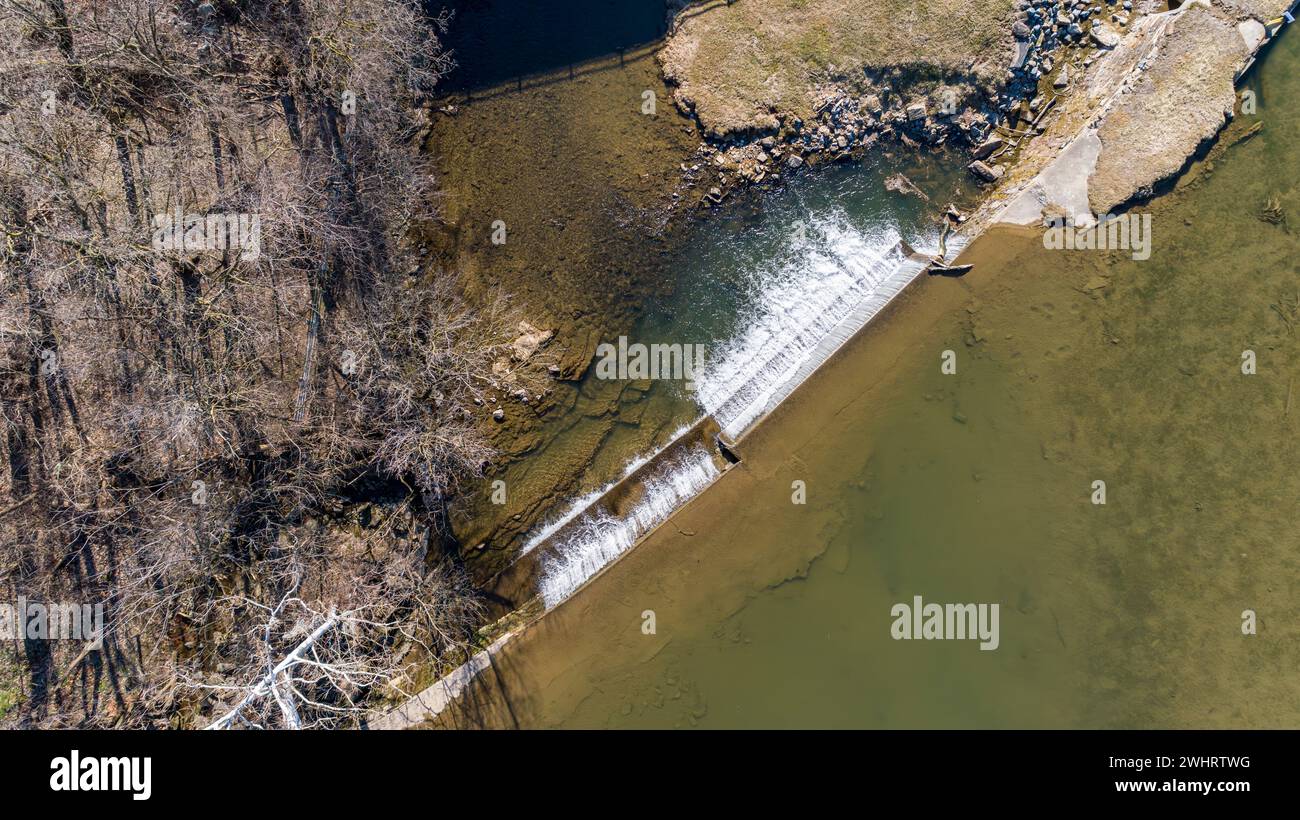 Aerial Downward View of a Man Made Waterfall for a Mill, on a Sunny Day Stock Photo