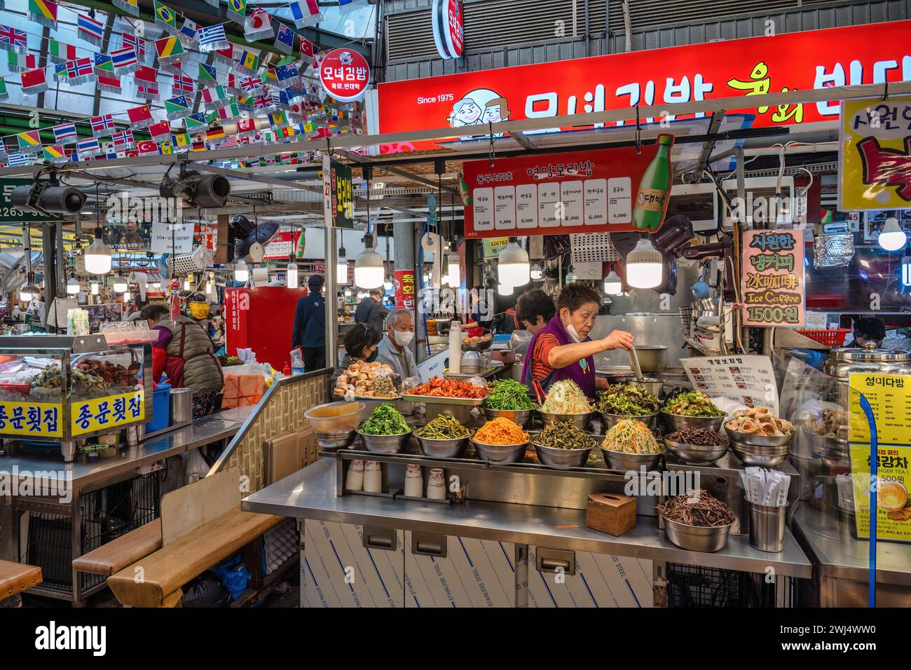 Seoul, South Korea - November 11, 2022 : shop and street food stall with many tourist at Gwangjang Market Stock Photo