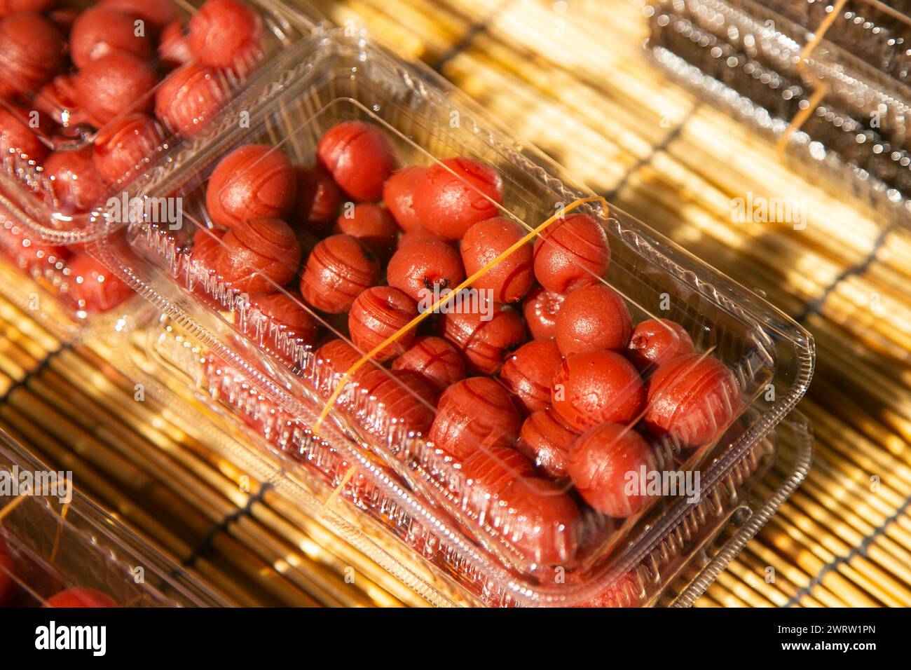 Umeboshi is a traditional Japanese dish, an ume pickle that is dried, salted in barrels, and a weight is placed on top to squeeze out the juice. Stock Photo