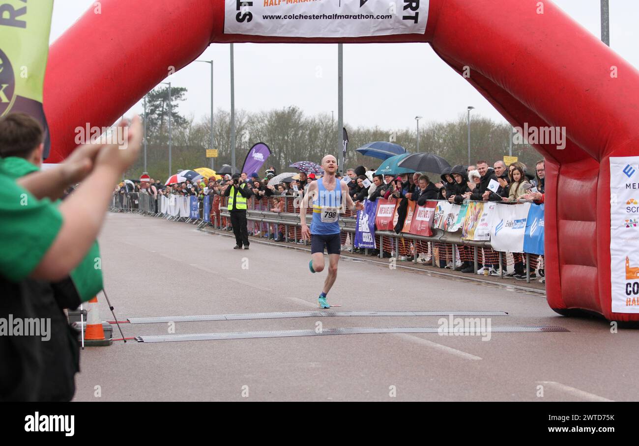 Colchester, UK. 17th Mar, 2024. The Colchester Half Marathon took place today in support of The Robin Cancer Trust. Despite the heavy rain around 2,500 runners started the race at the Jobserve Community Stadium, home of Colchester United FC. The winner crosses the finish line. Credit:Eastern Views/Alamy Live News Stock Photo