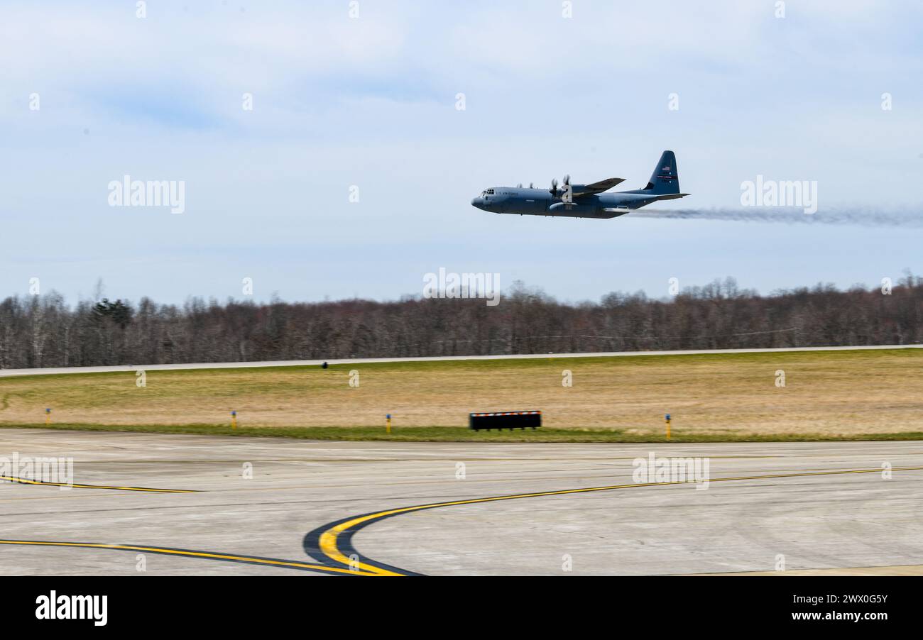 A C-130J-30 Super Hercules aircraft from Keesler Air Force Base, Mississippi, sprays water during a low pass at Youngstown Air Reserve Station, Ohio, as part of a flight test of the 910th Airlift Wing's unique electronic modular aerial spray system, March 25, 2024. The flight test was performed to ensure the operability of the spray system aboard the airframe as the 910th prepares to upgrade its aging C-130H Hercules fleet to new J-30 models. The project was carried out in partnership between 910th Airlift Wing maintenance personnel and aerial spray specialists, members of the Warner Robins Ai Stock Photo