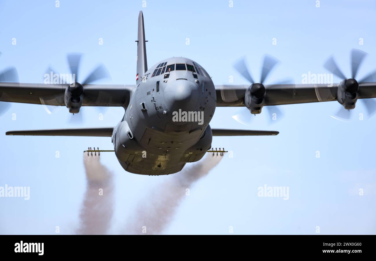 A C-130J-30 Super Hercules aircraft from Keesler Air Force Base, Mississippi, sprays water during a low pass at Youngstown Air Reserve Station, Ohio, as part of a flight test of the 910th Airlift Wing's unique electronic modular aerial spray system, March 25, 2024. The flight test was performed to ensure the operability of the spray system aboard the airframe as the 910th prepares to upgrade its aging C-130H Hercules fleet to new J-30 models. The project was carried out in partnership between 910th Airlift Wing maintenance personnel and aerial spray specialists, members of the Warner Robins Ai Stock Photo