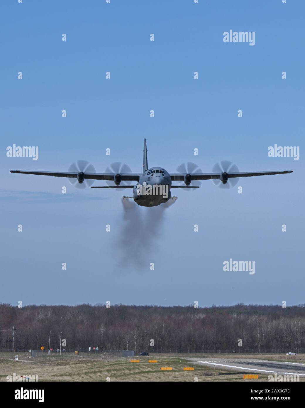 A C-130J-30 Super Hercules aircraft from Keesler Air Force Base, Mississippi, sprays water during a low pass at Youngstown Air Reserve Station, Ohio, as part of a flight test of the 910th Airlift Wing's unique electronic modular aerial spray system, March 25, 2024. The flight test was performed to ensure the operability of the spray system aboard the airframe as the 910th prepares to upgrade its aging C-130H Hercules fleet to new J-30 models. The project was carried out in partnership between 910th Airlift Wing maintenance personnel and aerial spray specialists, members of the Warner Robins Ai Stock Photo