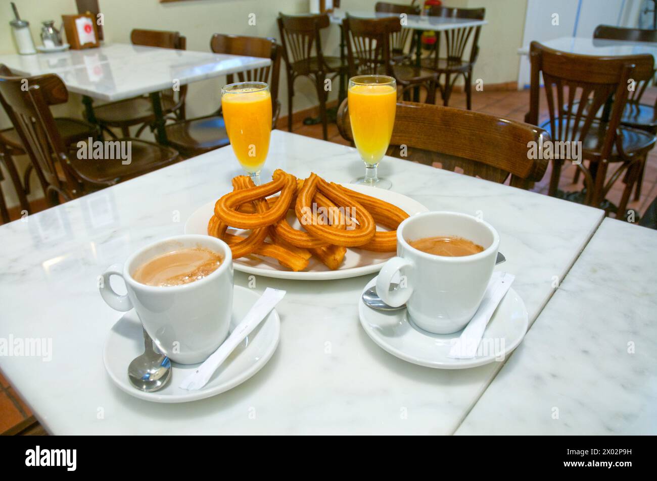 Typical breakfast: churros, coffee and orange juice. Madrid, Spain. Stock Photo