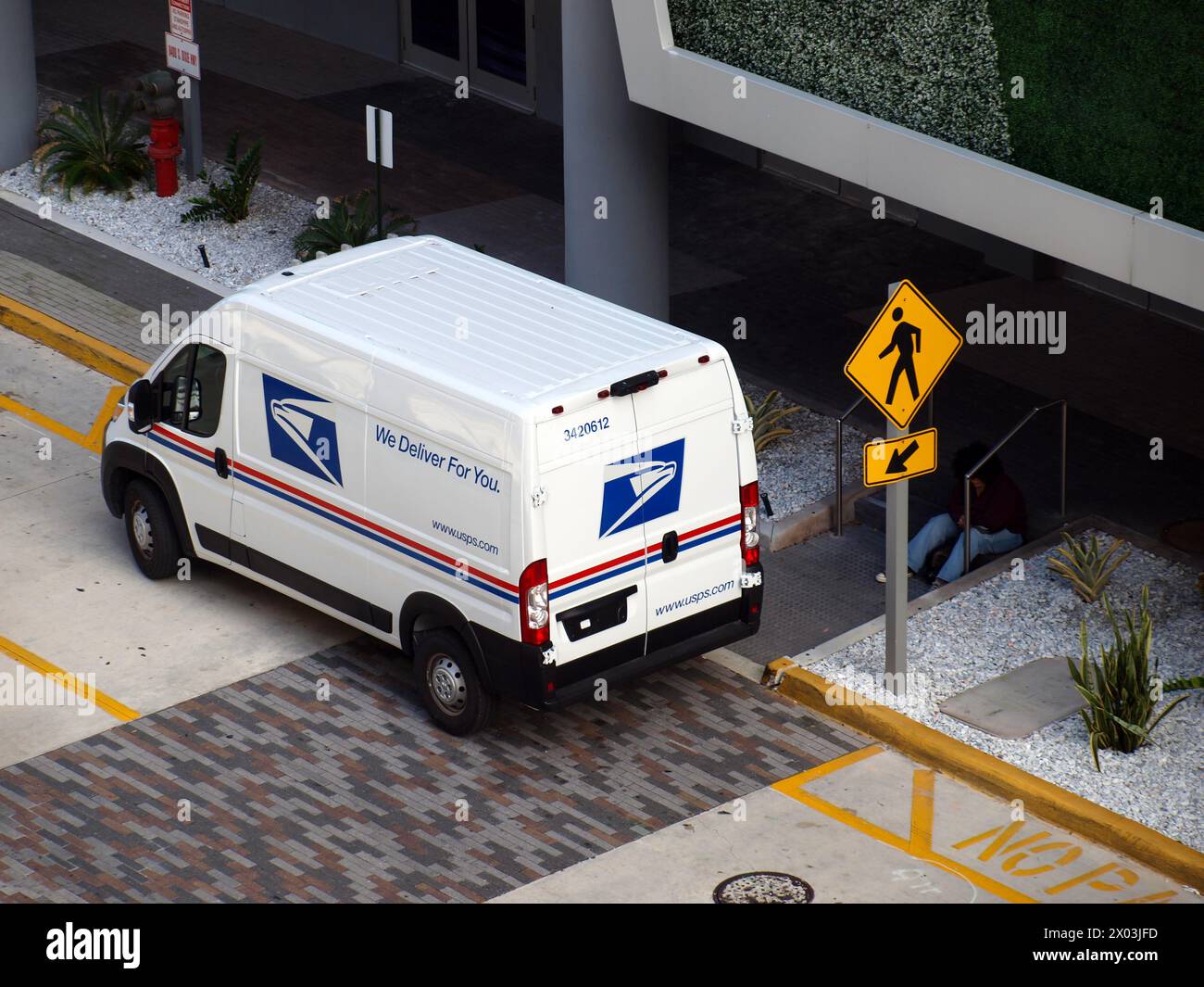 Miami, Florida, United States - April 6, 2024: Van of the US Postal Service (USPS) parked in a street. Stock Photo