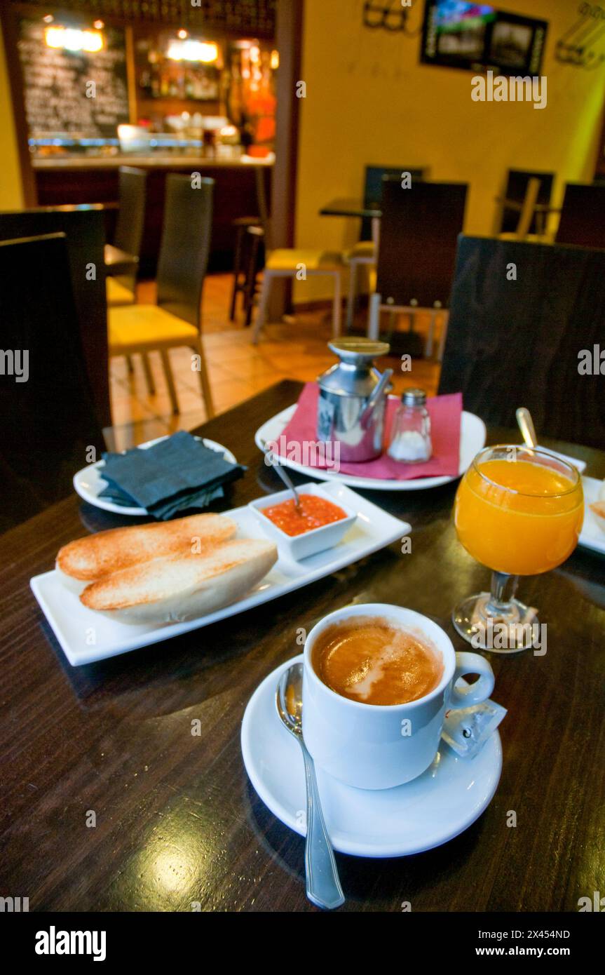 Spanish breakfast: toast with olive oil and tomato, orange juice and cup of coffee. Stock Photo