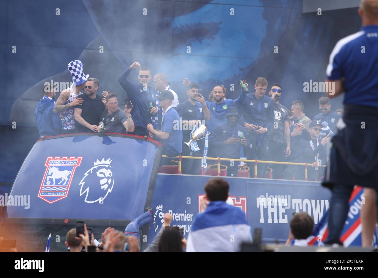 Ipswich, UK. 6th May, 2024. Ipswich Town Football Club celebrate back to back promotions, this season to the Premier League. Supporters gathered outside the ground in Portman Road to welcome the team bus at the start of the parade through the town. Flares were lit creating blue smoke to add to the atmosphere. Credit:Eastern Views/Alamy Live News Stock Photo