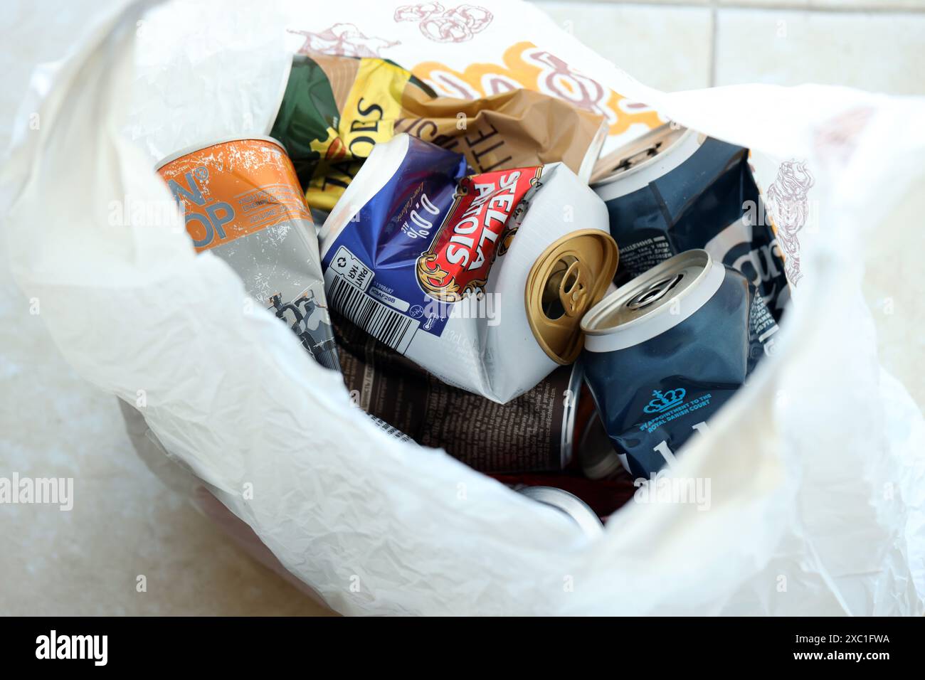 KYIV, UKRAINE - APRIL 20, 2024 Background of various crashed beer cans. Recycle aluminum metal crushed tin can waste close up Stock Photo