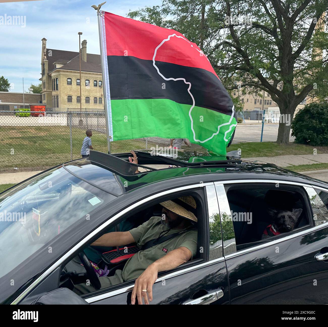 Racine, Wisconsin, USA. 15th June, 2024. A Pan-African flag is flown from a car in the Juneteenth Day parade in Racine, Wisconsin, Saturday June 15, 2024. (Credit Image: © Mark Hertzberg/ZUMA Press Wire) EDITORIAL USAGE ONLY! Not for Commercial USAGE! Stock Photo