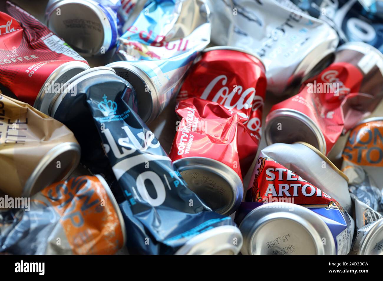 KYIV, UKRAINE - APRIL 20, 2024 Background of various crashed beer cans. Recycle aluminum metal crushed tin can waste close up Stock Photo